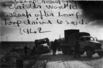 1942 - 2nd retreat from Barce in Libya. Had to drive fast and keep going. No time to rest. Driver fell asleep. Lorry was on its side and has been pulled back upright by lorry in foreground.